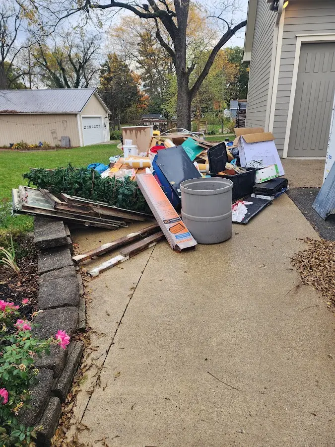 Dumpster being loaded with debris for Commercial Dumpster Rental in Pinson